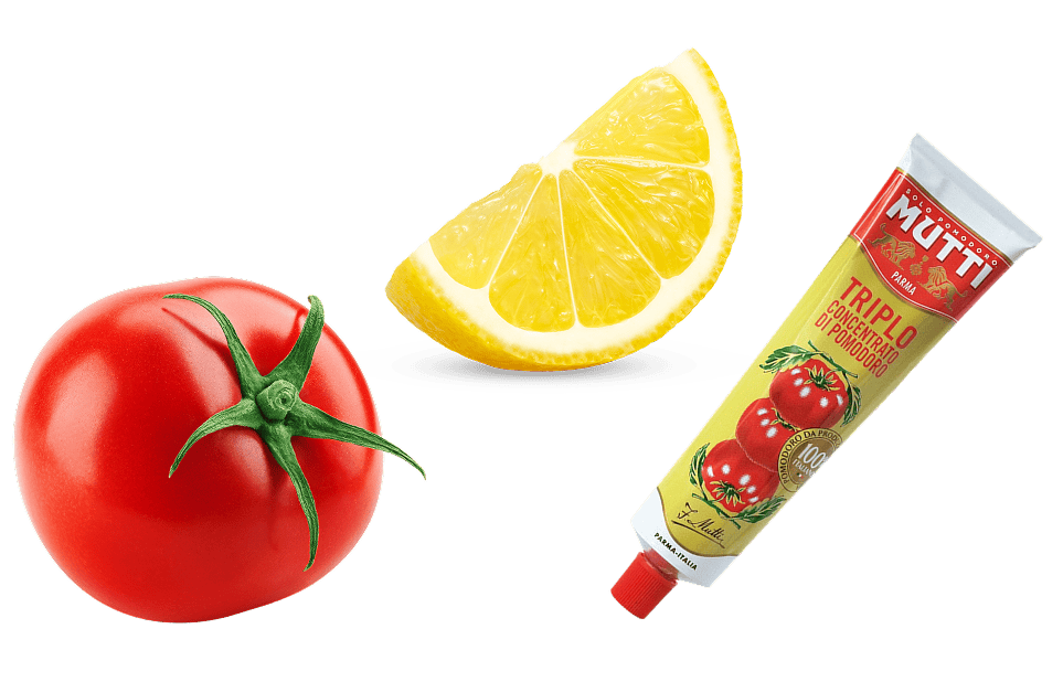 A whole tomato, a wedge of lemon, and a tube of Mutti tomato paste on a white background.