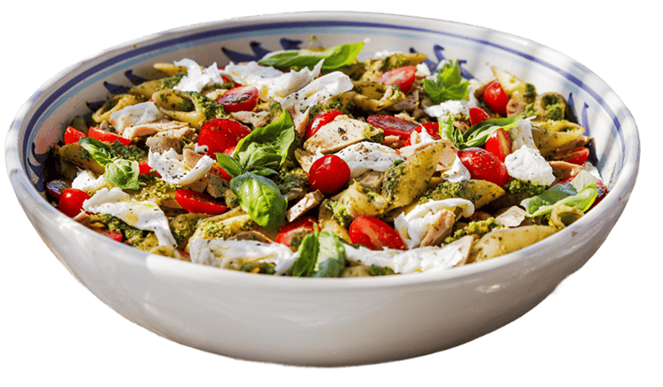 A bowl of pasta salad with cherry tomatoes, mozzarella pieces, basil leaves, chicken, and pesto sauce.